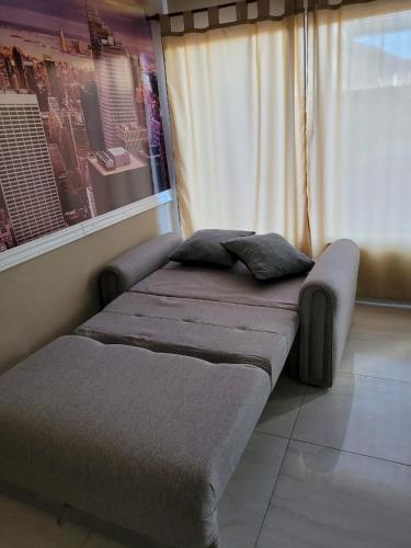 a bed sitting in a room with a window at la florida C in Salta