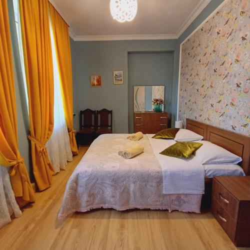 a bedroom with a bed with two towels on it at KOTE.GE in Lagodekhi