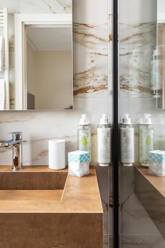 a bathroom with several bottles of soap on a counter at Hotel Villa Domizia in Porto Santo Stefano