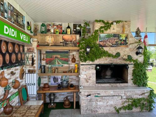 a kitchen with a stone fireplace in a store at Didvela Villa in Kutaisi