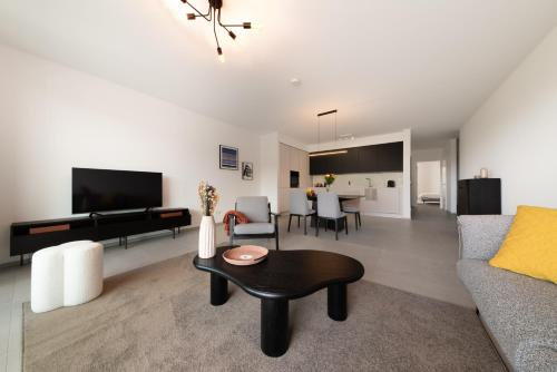 a living room with a couch and a table at Halternative Residence Renaissance in Luxembourg