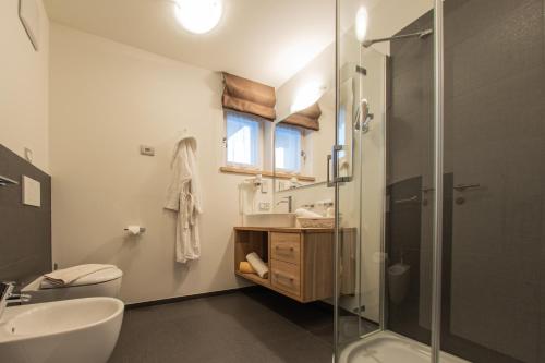 a bathroom with a sink toilet and a shower at Mountainlodge Luxalpine in San Vigilio Di Marebbe