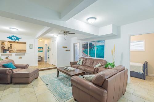 a living room with two couches and a table at Villa DeLuna in Pensacola Beach