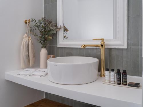 a white sink on a counter in a bathroom at St-Ten Stone Built Village in Áyioi Dhéka