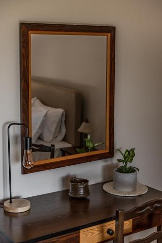 a mirror on top of a wooden desk with a bed at KissosInn in Kissós