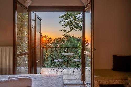a glass door leading to a balcony with a table at KissosInn in Kissós