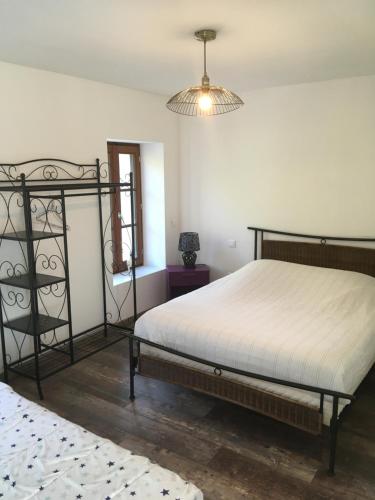 a bedroom with a bed and a chandelier at La marine D'opale in Ambleteuse