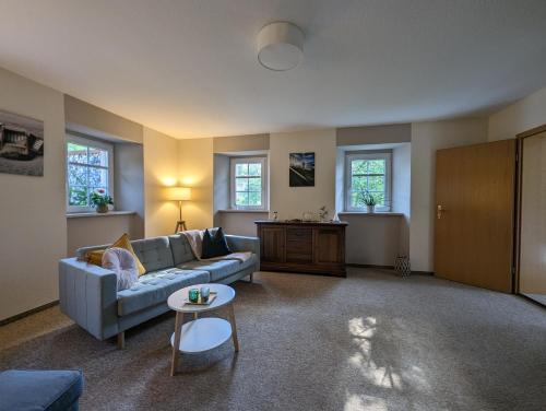 a living room with a couch and a table at Ferienwohnung grünes Haus Colditz in Colditz
