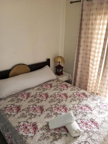 a bedroom with a bed with a towel on it at Elbernoussi in Casablanca