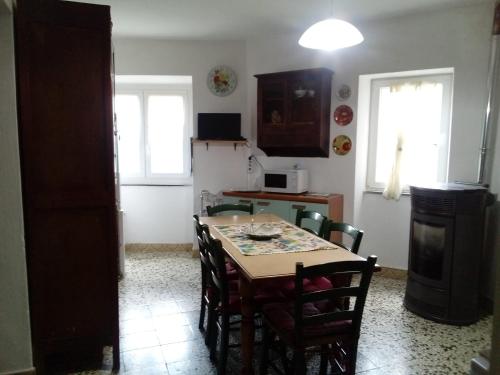 a kitchen with a table and chairs in a room at Casa vacanza toscana in Fivizzano