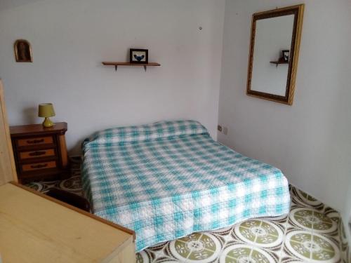 a bedroom with a bed and a mirror and a dresser at Casa vacanza toscana in Fivizzano