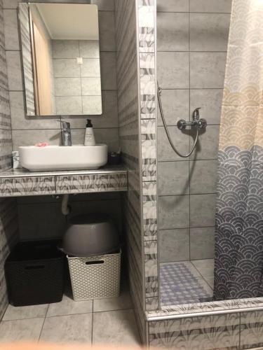a bathroom with a sink and a shower at The Urbanite in Kavála