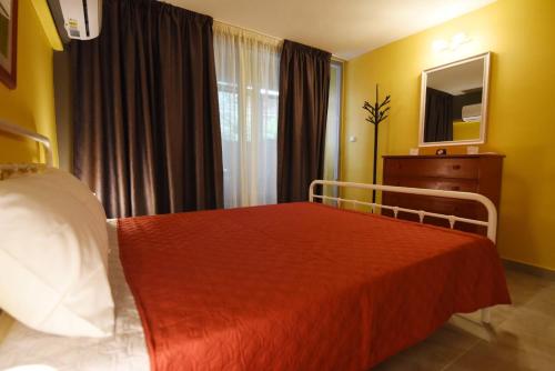 a hotel room with a bed and a window at The Urbanite in Kavála