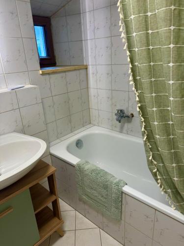 a bathroom with a bath tub and a sink at Rare Gem in Wasserburg in Wasserburg am Inn