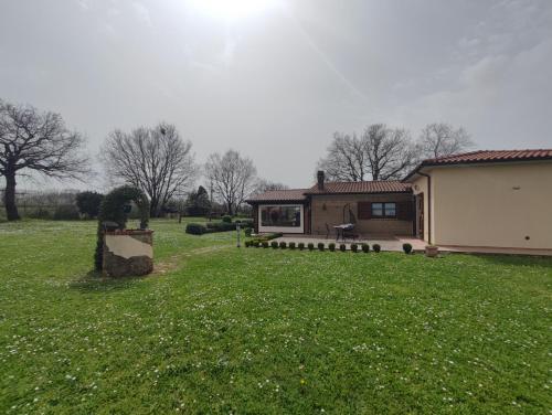 a house in a field with a grass yard at La Fratta in Sorano
