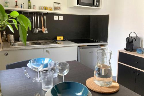 une cuisine avec une table avec des verres à vin dessus dans l'établissement Beautiful cozy studio of 23m in Marseille, à Marseille