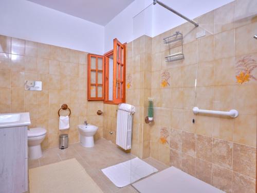a bathroom with a toilet and a sink and a shower at GP34 Affittacamere in Olbia