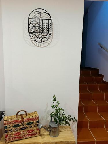 a room with a suitcase and a potted plant at Moinho do Duque in Runa