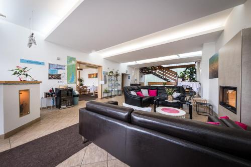a living room with a couch and a fireplace at Penzion Kozí Horka u Brněnské přehrady in Brno