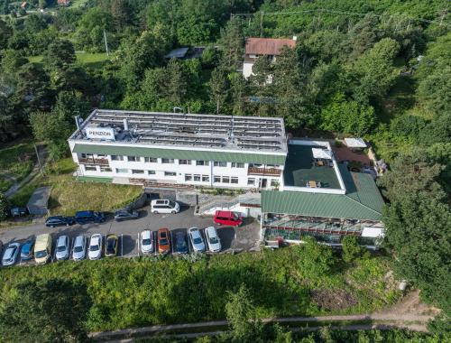an aerial view of a building with cars in a parking lot at Penzion Kozí Horka u Brněnské přehrady in Brno