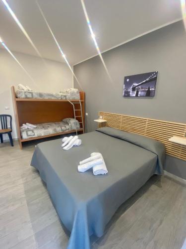 a bedroom with a bed with two towels on it at Glicine in Parghelia