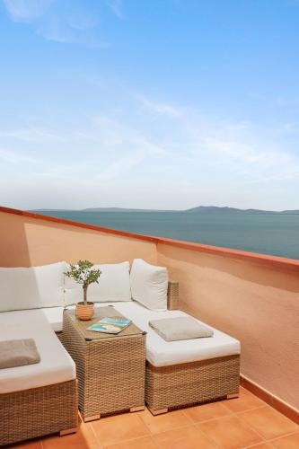 a balcony with a couch and a table on a boat at Hotel Villa Domizia in Porto Santo Stefano