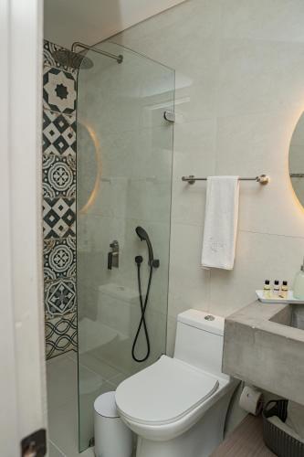 a bathroom with a shower and a toilet and a sink at Lunalá Hotel Boutique in Cartagena de Indias