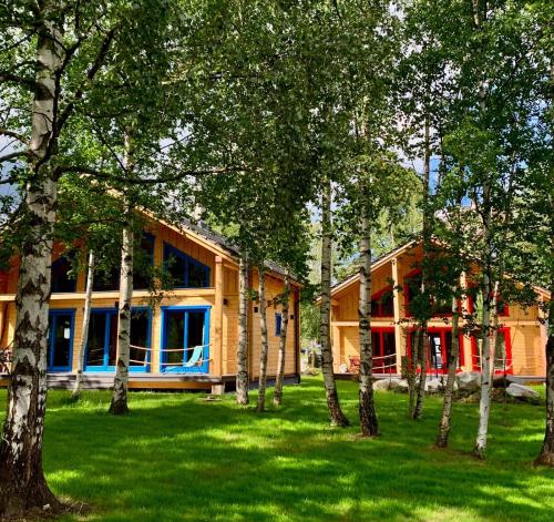 a house in the middle of a yard with trees at Chalets Buky in Tatranská Lomnica