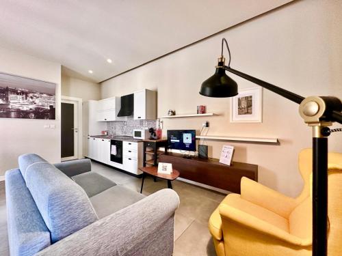 a living room with a couch and a table at Charming flat off the sea front in Il-Gżira