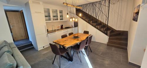 a kitchen and dining room with a wooden table and chairs at Villa Lavanda in Čižići