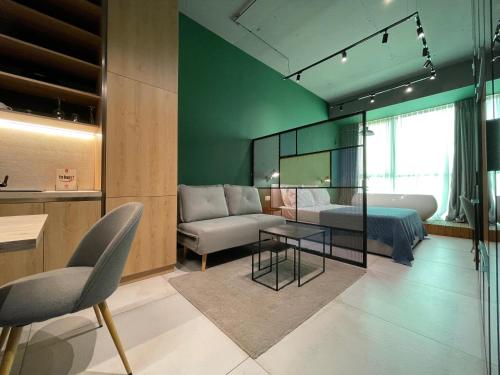 a room with a bed and a couch and a table at Ambassador Skyline Apartments in Tirana