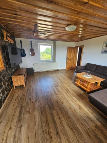 a living room with a couch and a table at TRUTH WINES HOUSE in Veliki Vrh
