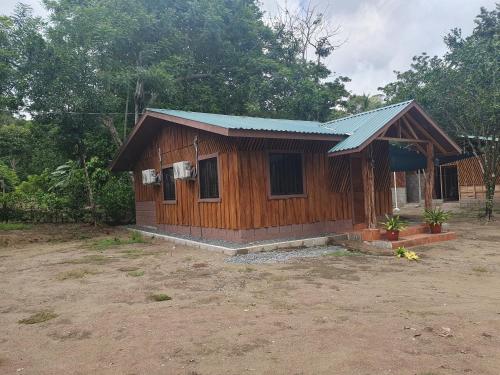 a small wooden house with a blue roof at Manzanillo Ecolodge in Golfito