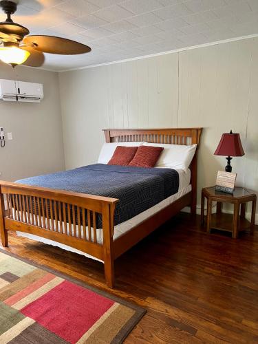 a bedroom with a large bed with a wooden frame at Cozy Corner In The City in Hot Springs