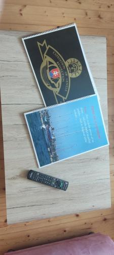 a remote control sitting on top of a wooden table at Privat 2 na Sihoti in Trenčín