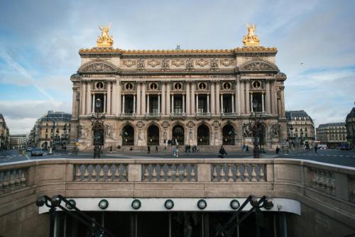 a large building with a bridge in front of it at Hôtel Lebron in Paris