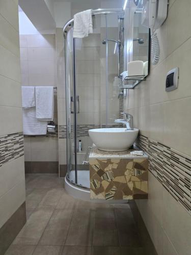 a bathroom with a sink and a shower at B&B Nazionale in Naples