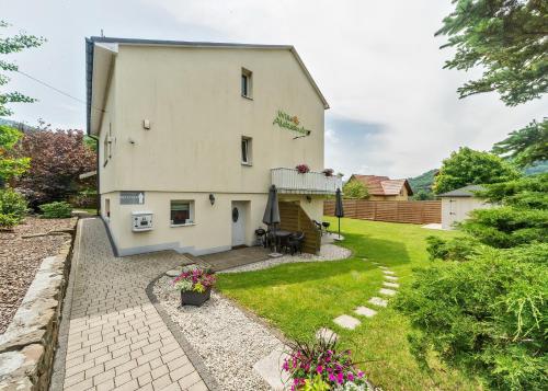 an image of a house with a garden at Willa Aleksandra - Apartamenty in Międzybrodzie Żywieckie