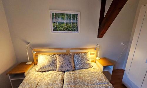 a bedroom with a bed with two lamps and a window at Park Apartment in Kraków