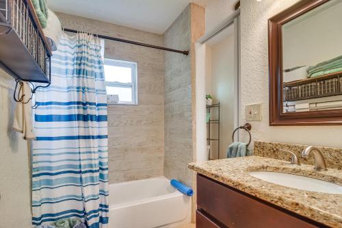 a bathroom with a sink and a tub and a shower at Charming Seminole Home with Patio 6 Mi to Beaches! in Seminole