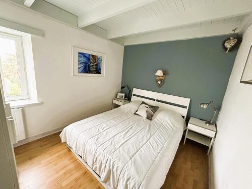 une chambre avec un lit blanc et un mur vert dans l'établissement Maison typique Oléronaise au cœur de l'île d'Oléron, à Saint-Georges-dʼOléron