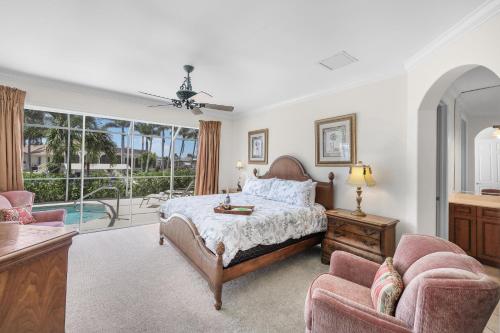 a bedroom with a bed and a balcony at Pet-friendly waterfront home near beach with pool in Marco Island