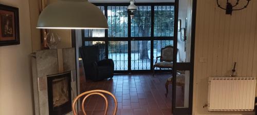 a living room with a fireplace and a large glass door at 7 Olmi b&b Bologna in Carteria di Sesto Rastignano