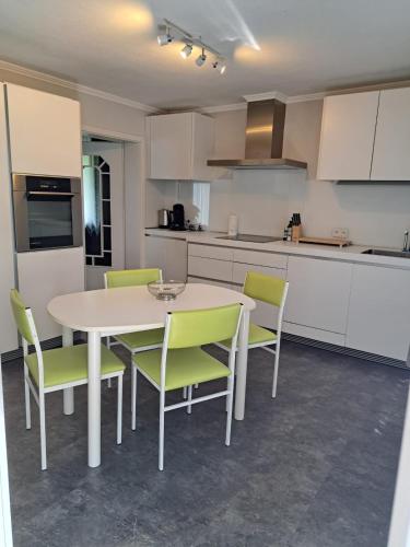 a kitchen with a white table and chairs in a room at Vitus-Perle in Saint-Vith