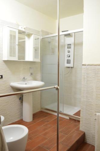 a bathroom with a glass shower and a sink at Villa Grazia in Aci Catena
