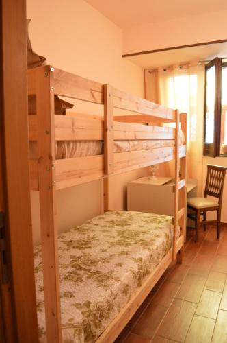 a bedroom with two bunk beds and a desk at Villa Grazia in Aci Catena