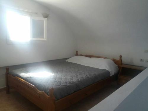 a bed in a bedroom with a window at Paradise Serenity in Thólos