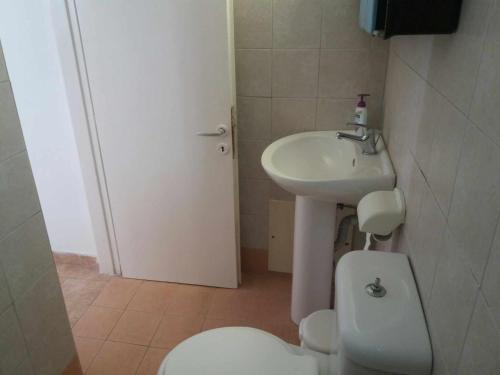 a small bathroom with a toilet and a sink at Paradise Serenity in Thólos