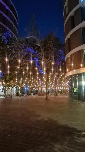 a tree with lights on it in front of a building at Florentin House - By HOMY in Tel Aviv