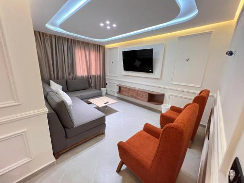 a living room with a couch and a tv at anza in Agadir